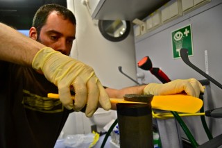 Renald Belley slicing samples from one of the sediment cores. 