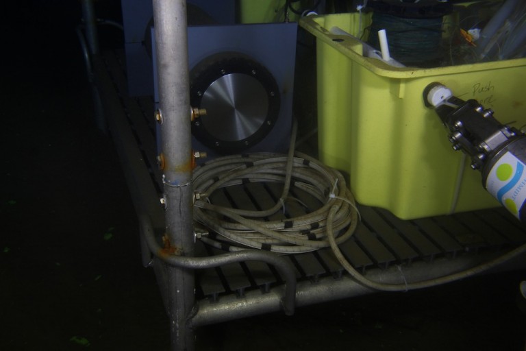 The ROV pilots guide the manipulator arm to push a lever that closes the valve on the MIMOSA sampler.