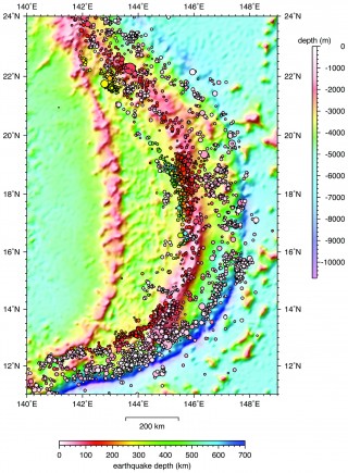 Color contoured bathymetry map of the Mariana arc showing the distribution of earthquakes in the region.  The larger the dot, the greater the magnitude, and the cooler the color, the deeper the site of the earthquake.  