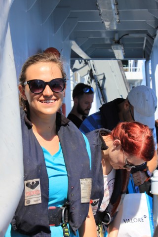 Safety first, Julianna sports a life jacket before entering the work boat. 