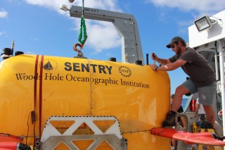 Ben Pietro on the AUV Sentry team from Woods Hole Oceanographic Institute (WHOI) makes sure that everything is running smoothly on the vehicle prior to deploying it. 