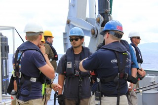 The Woods Hole Oceanographic Institute (WHOI) meet on the aft deck to debrief after Sentry trials.