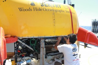 Justin Fujii, the Sentry mechanical engineer works to put a cooling line in the AUV.