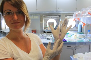 Institute of European Marine Sciences graduate student Isabelle Bacconais demonstrates a water sample from Loihi that shows the presence of iron. 