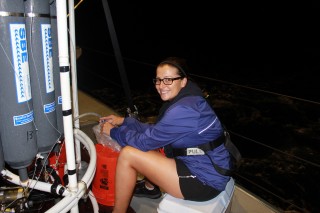 University of Hawaii Graduate student Kristen Fogaren, collects seawater samples from the Niskin bottles after the CTD is brought back to Falkor. 