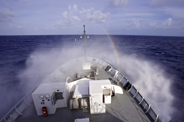 Rainbow in the mist off of the bow