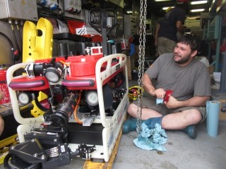 Marine Technican Leighton Rolley works on the ROV on the aft deck of Falkor. 