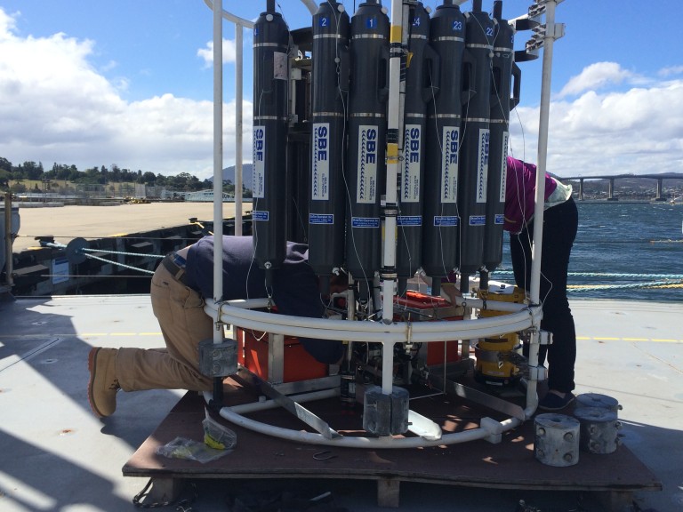 Sam Kelly and Gabriela Pilo get lost in the CTD cage while attaching batteries to power the ADCPs. 