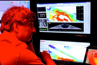 Chief scientist Christopher Kelley following incoming data in the control room.