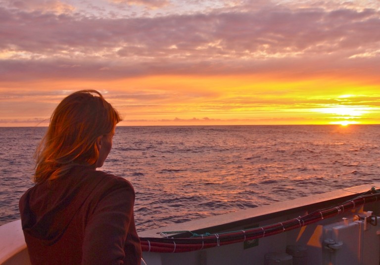 An optimist (Julie Huber) assessing the sunrise seas.