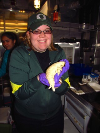 Caitlin Plowman, a recent graduate of the Oregon Institute of Marine Biology holds a 26cm Supergiant amphipod (Alicella gigantea). 