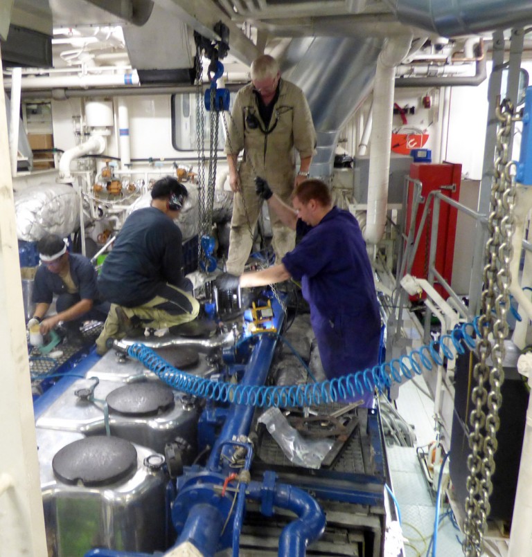 Chief Engineer Allan Watt, 2nd Engineer Douglas Hay, and Engineering crew Dante Sarzuela and Edwin Pabustan replacing a cylinder head on the port engine. 