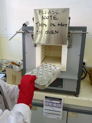 Scientists cleaning bottles for water chemistry analyses by heating them in the furnace. 