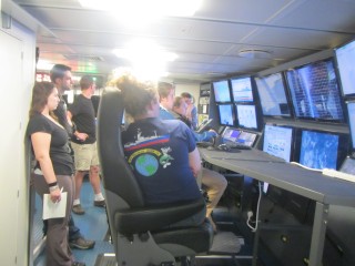 Scientists view a CTD profile on screen in the Science Control Room as the rosette is lowered. 