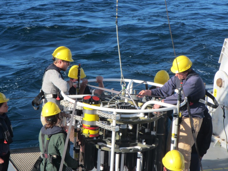 Scientists cock open the Niskin bottles that will collect seawater at depth for this test launch. 