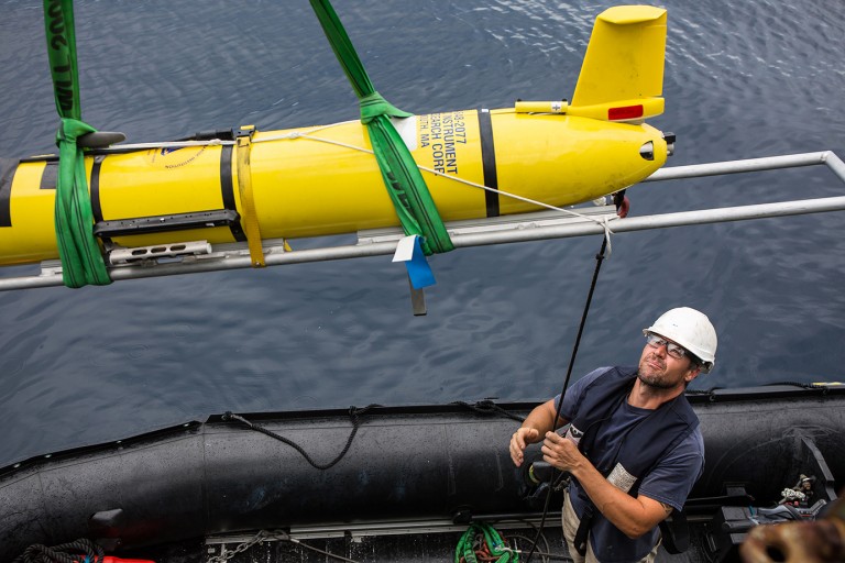 Michael Utley helps lower the Slocum Glider into a zodiac for ballasting calibration. 