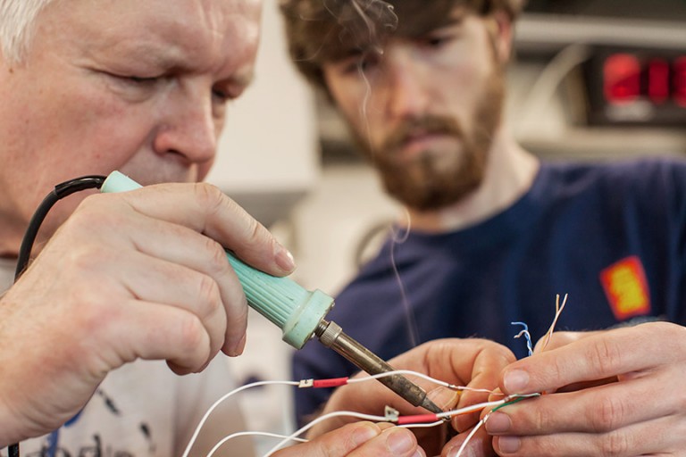 Georgiy Pleskach and William Snyder work on wiring the Lagrangian Float in Falkor’s Wet Lab on the journey to Scott Reef. 