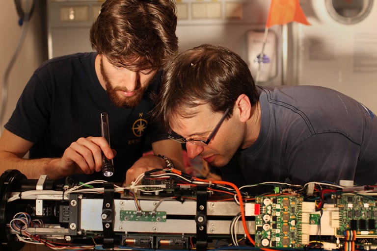 William Snyder and Professor Chris Roman troubleshoot power issues before launching the Lagrangian Float for the first time.