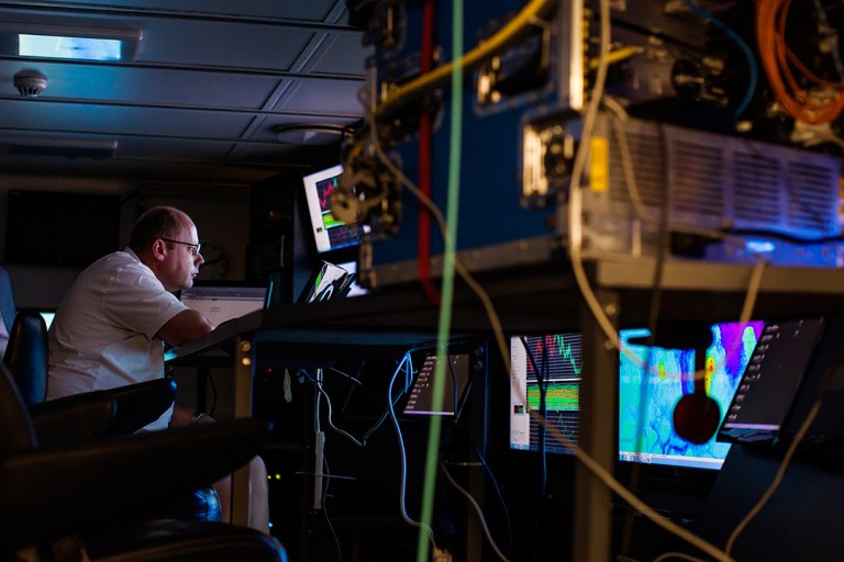 Marine Tech Paul Duncan mans incoming data from Falkor’s multi-beam sonar late into the night.