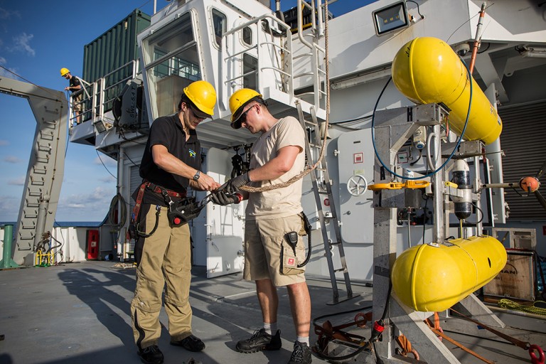 2nd Office Oliver Hurdwell and crew prepare to lift and deploy AUV Sirius by a crane on the aft deck.