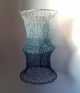 Yarn and silk, combined in a gradient of silver and blues meant to show the presence of light at the surface and its extension through the water. 