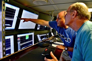 Wes Tunnell (right), a lead scientist, and marine technician Nathan Cunningham (left) at the multibeam sonar mapping station.