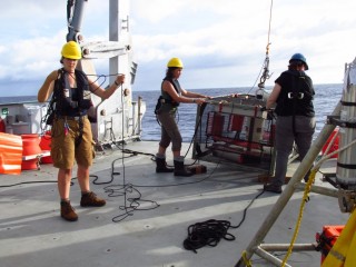 Deployment of the hadal fish trap from the Falkor. From L to R: Mackenzie Gerringer, formerly an undergraduate researcher and now a graduate student; Chloe Weinstock, a current undergraduate researcher; and Dr. Jill Bourque, USGS. 