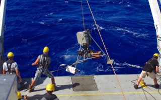 Retrieving the hadal video lander with its tubular amphipod traps from the Sirena Deep.